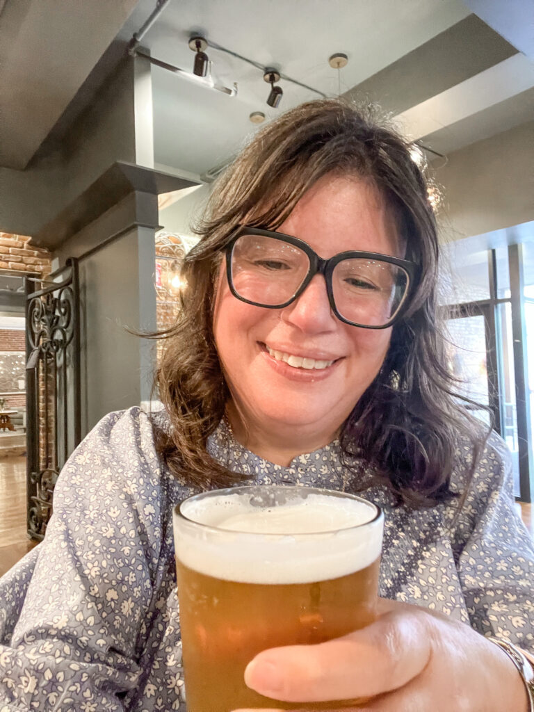 Nikki holding a beer